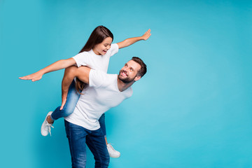 Profile side photo of cheerful people holding hands playing piggyback wearing white t-shirt denim...