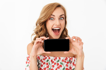 Emotional young woman posing isolated over white wall background showing display of mobile phone.