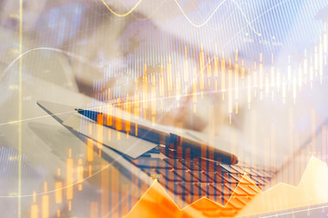 Forex market chart hologram and personal computer background. Multi exposure. Concept of investment.