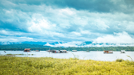 Rafting house on lake .beautiful landscape  with foggy over mountains on background in Kanchanaburi Thailand