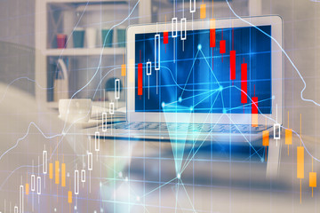 Financial chart drawing and table with computer on background. Double exposure. Concept of...