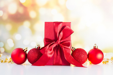 Christmas or new year decorations, red gift box and balls with  bokeh lights