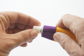 Patient squeezes out of aluminum tubes ointment with medicinal substance on finger. Photo of use of drug in form of ointments for application on skin and treating skin diseases, psoriasis, acne