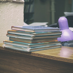 Old books in a stack on a wooden table