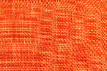 Fototapeta premium Rough bright orange fabric texture for background and design