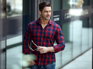 Handsome smiling man in checked shirt