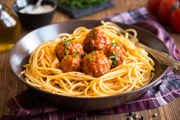 Delicious spaghetti with meatballs in tomato sauce on dark background, italian cuisine - obrazy, fototapety, plakaty