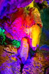 Beautiful illuminated multicolored stalactites in Danzhou Stone Flower Caves, Geopark next to Haikou, Hainan, China