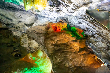Beautiful illuminated multicolored stalactites in Danzhou Stone Flower Caves, Geopark next to Haikou, Hainan, China