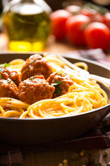 Delicious spaghetti with meatballs in tomato sauce on dark background, italian cuisine