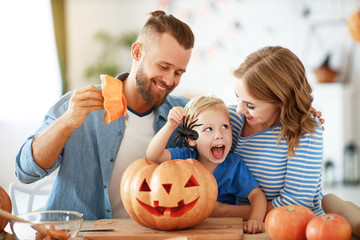 happy  family mother father and child son prepare for Halloween decorate  home with pumpkins and ...