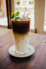 Iced latte coffee on wooden table in cafe