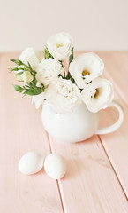 Fototapeta na wymiar Easter flowers and eggs. Festive Easter spring composition with flowers and eggs. Easter Background. Springtime. Invitation card design with copy space. Easter card template
