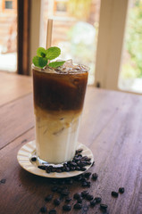 Iced latte coffee on wooden table in cafe