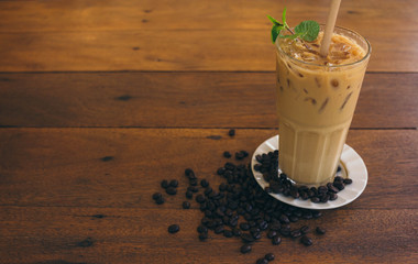 Iced latte coffee on wooden table in cafe