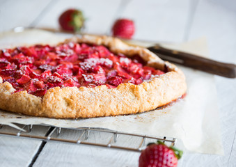 Homemade sweet strawberry cake with fresh strawberries on white wooden table