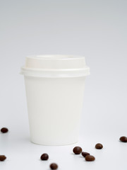 Coffee shop mockup: white paper small espresso coffee cup. Side view on blue background. Copy Space for text