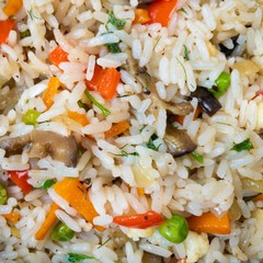 Close view on white rice cooked with vegetables.