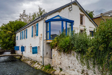 Fototapeta na wymiar Old house along the river of tone with blue shutters