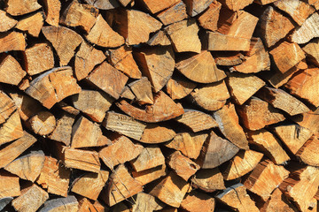 Chopped firewood is stacked. Harvesting wood for the heating season