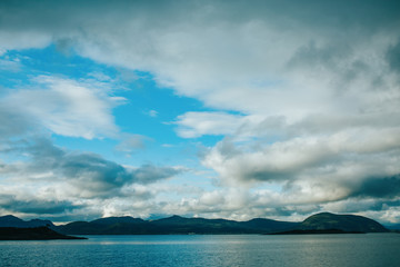 Photo of hills, sea, sky in Norway on summer.
