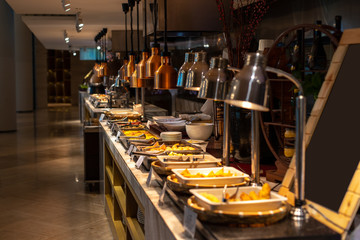 Buffet breakfast at a Chinese hotel. Blurry background of food trays. Breakfast is included in the hotel.