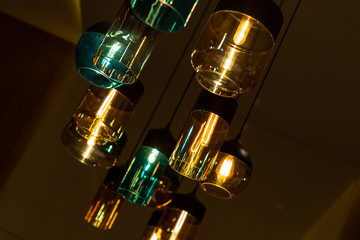 Modern indoor lighting. Beautiful colored glass shades. Pleasant warm and cold tones.