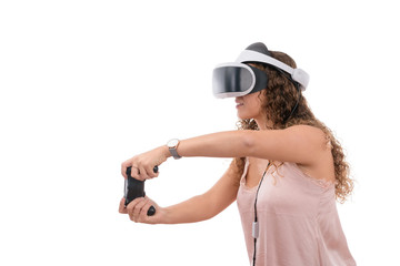 Caucasian young women playing with reality glasses and virtual console controller dressed in a pink shirt isolated in white background