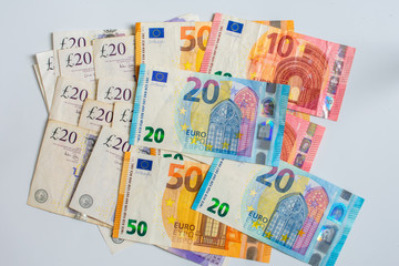 20 pound and 10 20 50 euro isolated on white background close up top view, currency exchange