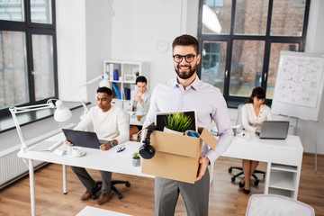 business, new job and quit concept - happy smiling male office worker with personal stuff