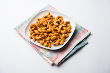 Masala Kaju or spicy Cashew in a bowl. Popular festival snack from India/asia, also known as Chakna...