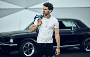 Handsome man with black classic car wear smart casual