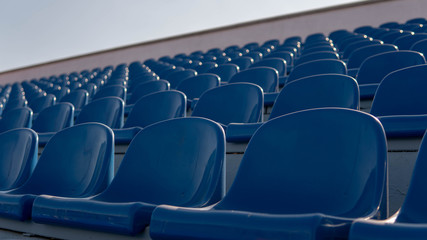 Fototapeta premium Bleachers in a sports stadium. Blue Seats In A Row