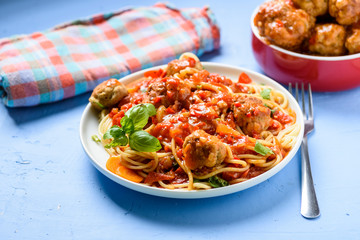 homemade pasta with tomato sauce and cooked meatballs