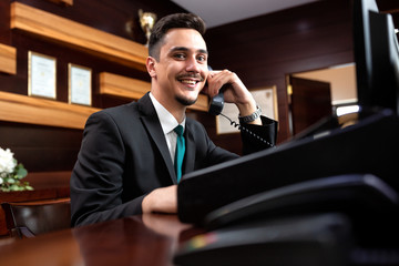 Elegantly dressed receptionist holding a headphone