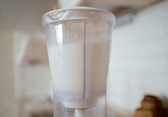 Blender and almonds soaked in water. Homemade healthy vegan milk.