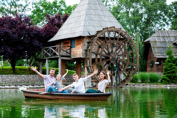 Obraz premium Happy family of four in the boat