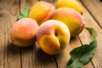 Sweet ripe peaches on the rustic background. Selective focus. Shallow depth of field.