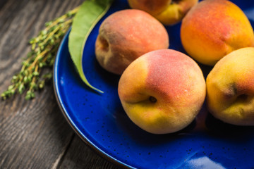 Sweet ripe peaches on the rustic background. Selective focus. Shallow depth of field.