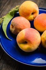 Sweet ripe peaches on the rustic background. Selective focus. Shallow depth of field.