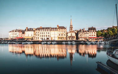 Fototapeta na wymiar HONFLEUR, FRANCE - MAY4, 2018:Waterfront reflection of traditional houses in Honfleur, Normandy, France
