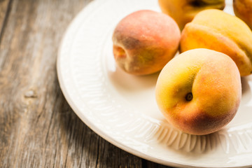 Sweet ripe peaches on the rustic background. Selective focus. Shallow depth of field.