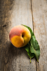 Sweet ripe peaches on the rustic background. Selective focus. Shallow depth of field.