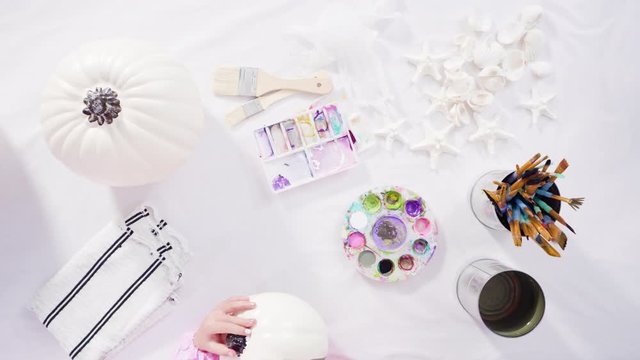 Flat lay. Step by step. Painting craft pumpkin with acrylic paint to create decorated mermaid Halloween pumpkin.