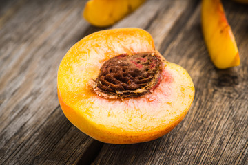Sweet ripe peaches on the rustic background. Selective focus. Shallow depth of field.