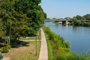 Bridge and hiking path along river Weser in Minden, Germany