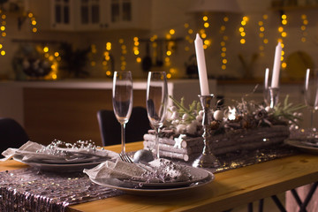 New Year's interior with a table, glasses, noodles, lights.