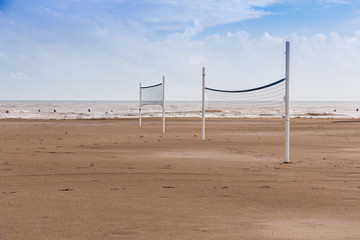 Beach volleyball court on the sand near the water on a beach without people,