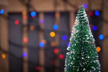 Christmas tree on multicolored blurred background