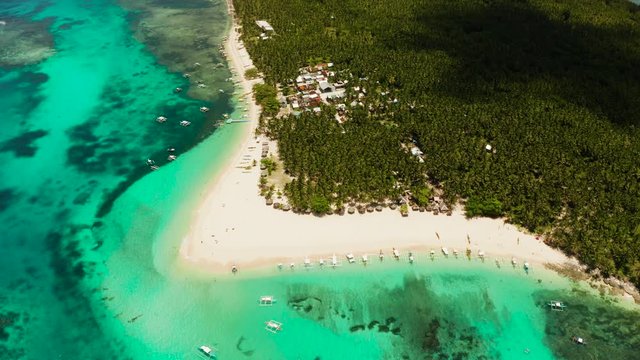 Beautiful tropical island in sunny weather, view from above. Daco island, Philippines. White sandy beach and turquoise lagoon.